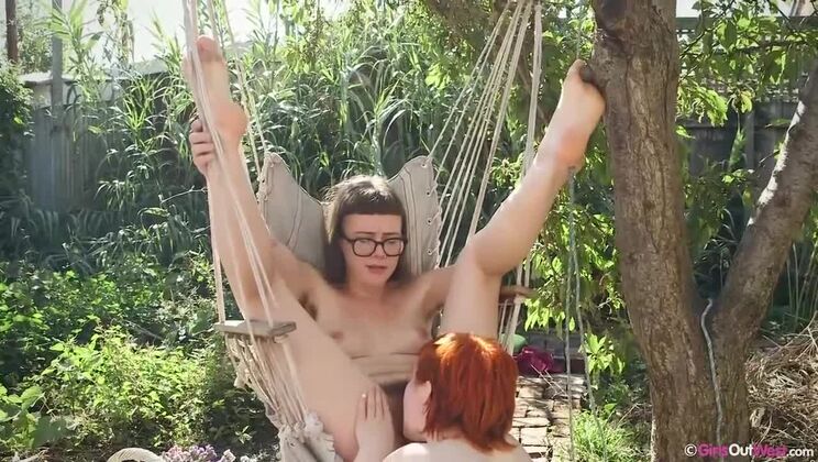 Redhead and Brunette Lesbians at Outdoor Party